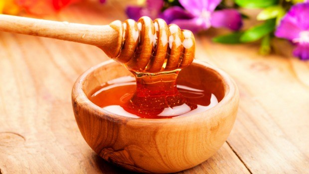 Honey dipper in a wooden bowl